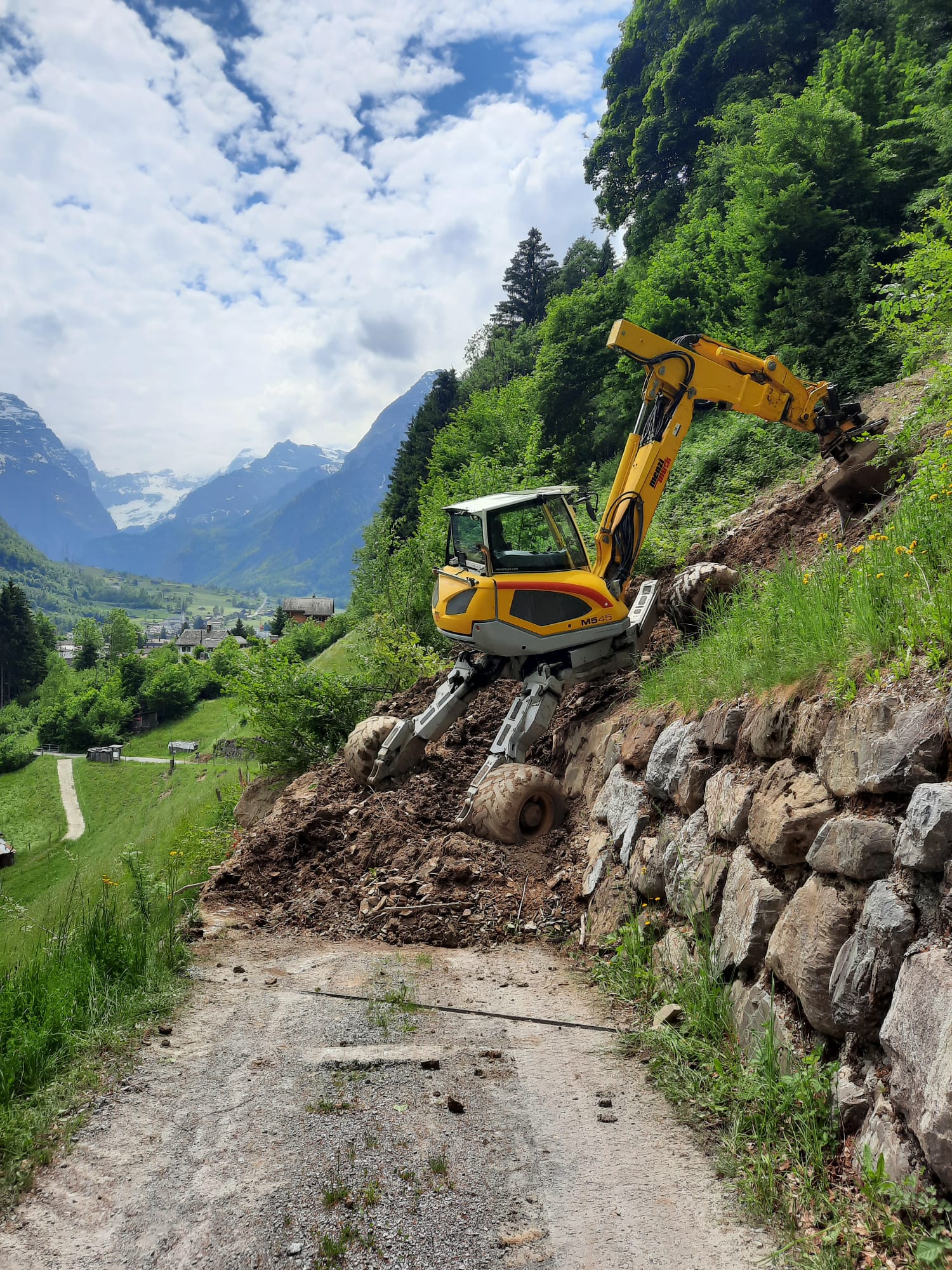 yellow and black excavator on rocky ground